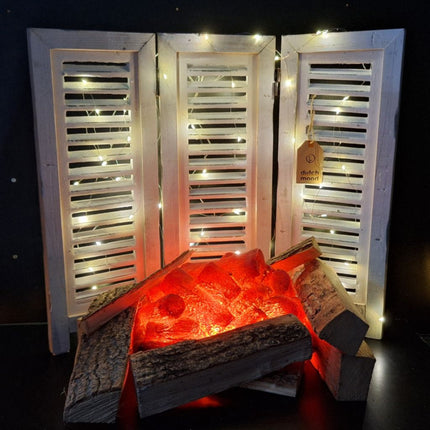 Sfeervolle wintersetting met houten luiken, kerstlichtjes en natuurlijke decoraties